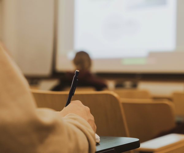 Student taking notes during lecture