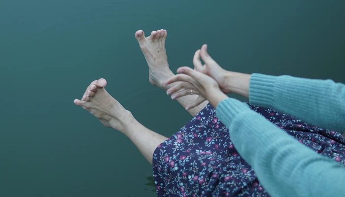 Person reaching for their feet