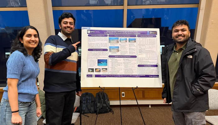 Three CDS students standing with poster